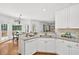 Well-lit kitchen featuring granite countertops, stainless appliances, and a cozy breakfast nook at 672 Red Sunset Cir, Powder Springs, GA 30127