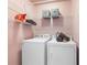 Convenient laundry area equipped with shelving, a washer, and a dryer at 672 Red Sunset Cir, Powder Springs, GA 30127