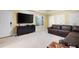Living room with a leather couch and a large screen television on top of black dresser at 672 Red Sunset Cir, Powder Springs, GA 30127