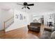 Open-concept living room with hardwood floors and staircase in a bright and airy home at 672 Red Sunset Cir, Powder Springs, GA 30127