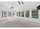 Spacious sunroom with large windows offering outdoor views, ceiling fans, and easy access to the deck at 672 Red Sunset Cir, Powder Springs, GA 30127