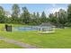 Well-maintained tennis courts with a covered gazebo and benches, set against a backdrop of mature trees at 672 Red Sunset Cir, Powder Springs, GA 30127