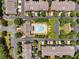 Aerial view of the community pool and nearby homes with tree lined streets and parking at 11271 Calypso Dr, Alpharetta, GA 30009