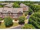 Aerial view of townhomes surrounded by mature trees and landscaping at 11271 Calypso Dr, Alpharetta, GA 30009