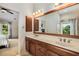 Bathroom with double sinks, tile flooring, a bathtub, and a glass-enclosed shower at 11271 Calypso Dr, Alpharetta, GA 30009