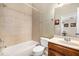 Clean bathroom featuring a shower and tub combination with tile surround and a wood vanity at 11271 Calypso Dr, Alpharetta, GA 30009