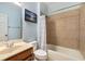 Bright bathroom featuring a tiled shower and tub combination next to a clean vanity at 11271 Calypso Dr, Alpharetta, GA 30009