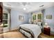 Well-lit bedroom features neutral paint, a ceiling fan, and views of the green outdoors at 11271 Calypso Dr, Alpharetta, GA 30009
