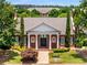 Charming brick clubhouse entrance with white columns and manicured landscaping at 11271 Calypso Dr, Alpharetta, GA 30009