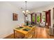 Traditional dining room with hardwood floors and chandelier lighting at 11271 Calypso Dr, Alpharetta, GA 30009