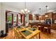 Elegant dining room open to kitchen and sunroom at 11271 Calypso Dr, Alpharetta, GA 30009