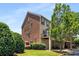 The back of the townhome boasts a balcony, two-car garage and brick veneer at 11271 Calypso Dr, Alpharetta, GA 30009