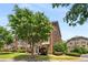 Attractive brick townhome with flowering tree and manicured landscaping at 11271 Calypso Dr, Alpharetta, GA 30009