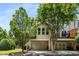 Neutral townhouse exterior featuring garage and a small balcony with landscaping at 11271 Calypso Dr, Alpharetta, GA 30009