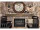 Stone fireplace with round mirror and bench seating on either side at 11271 Calypso Dr, Alpharetta, GA 30009