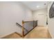 Hallway with carpet, traditional wood railing, and a white door leading to another room at 11271 Calypso Dr, Alpharetta, GA 30009
