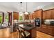 Updated kitchen featuring granite countertops, a gas cooktop island, stainless appliances, and wood cabinets at 11271 Calypso Dr, Alpharetta, GA 30009