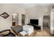 Bright home office with neutral walls, wood desk, and dark accent furniture near bathroom and closet at 11271 Calypso Dr, Alpharetta, GA 30009