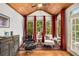 Bright sitting room showcases wood ceiling, multiple windows, and stylish furniture for relaxation at 11271 Calypso Dr, Alpharetta, GA 30009