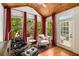 Cozy sitting room with tongue and groove vaulted ceiling, bright windows, and access to the balcony at 11271 Calypso Dr, Alpharetta, GA 30009