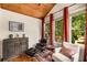 Inviting sitting room with tongue and groove vaulted ceiling, large windows, and comfortable seating at 11271 Calypso Dr, Alpharetta, GA 30009