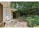 Patio and lush backyard with mature trees and privacy fence at 1194 Robert Ln, Marietta, GA 30062