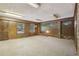 Spacious basement features wood paneling, brick accents, carpet and natural light at 1194 Robert Ln, Marietta, GA 30062