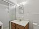 Tiled bathroom with glass shower door, single sink vanity, and modern lighting at 1194 Robert Ln, Marietta, GA 30062