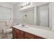 Bathroom features a large mirror, window, and a wooden vanity with white countertop at 1194 Robert Ln, Marietta, GA 30062