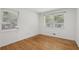 Bright bedroom features hardwood floors and natural light from two windows at 1194 Robert Ln, Marietta, GA 30062