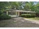 Charming single-story home with a mature trees, a driveway, and shuttered windows at 1194 Robert Ln, Marietta, GA 30062