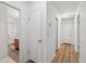 Bright hallway features gleaming hardwood floors and leads to a bathroom and other rooms at 1194 Robert Ln, Marietta, GA 30062