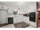 Efficient kitchen with white cabinets, black appliances, and a window for natural light at 1194 Robert Ln, Marietta, GA 30062