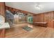 Warm living room featuring a brick fireplace, wood paneling, and hardwood floors at 1194 Robert Ln, Marietta, GA 30062