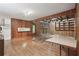 Spacious living area with a brick fireplace, hardwood floors, and natural wood wall paneling at 1194 Robert Ln, Marietta, GA 30062