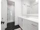 Well-appointed bathroom with a sleek vanity, dark herringbone floors, and a glass-enclosed shower at 144 Northern Ave, Decatur, GA 30030