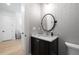 Elegant powder room featuring a granite vanity, modern lighting, and decorative wallpaper at 144 Northern Ave, Decatur, GA 30030