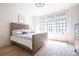 Well-lit bedroom features hardwood floors, large windows, and neutral decor at 144 Northern Ave, Decatur, GA 30030