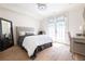 Cozy bedroom with French doors, hardwood floors, a desk, and a full length mirror at 144 Northern Ave, Decatur, GA 30030