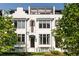 Elegant white townhome with black window trim, shutters, and iron railing fence at 144 Northern Ave, Decatur, GA 30030