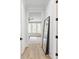 Hallway with wooden floors, doorways, and mirror at 144 Northern Ave, Decatur, GA 30030