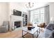 Cozy living room showcasing a stone fireplace, a large window, and elegant decor at 144 Northern Ave, Decatur, GA 30030