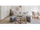 Stylish living room with accent wall, neutral furniture, and a glass coffee table at 144 Northern Ave, Decatur, GA 30030