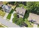 Birds-eye view of a home highlighting its location, roof design, and expansive yard with mature trees at 558 Grand Ivey Pl, Dacula, GA 30019