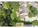 An aerial view shows the home's backyard featuring manicured lawn and patio with firepit and patio table at 558 Grand Ivey Pl, Dacula, GA 30019