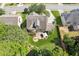 An aerial view of a home with a well-kept lawn, patio with a fire pit, and a patio dining set at 558 Grand Ivey Pl, Dacula, GA 30019