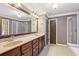 Bright primary bathroom featuring double vanity, glass enclosed shower and soaking tub with tile surround at 558 Grand Ivey Pl, Dacula, GA 30019