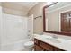 Bathroom featuring a vanity, toilet, and a shower-tub combo with white tile surround at 558 Grand Ivey Pl, Dacula, GA 30019
