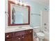 Bathroom featuring blue walls, vanity, mirror, toilet, and a shower/tub combo at 558 Grand Ivey Pl, Dacula, GA 30019