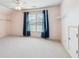 Airy bedroom showcasing a ceiling fan, a window with curtains, and storage spaces at 558 Grand Ivey Pl, Dacula, GA 30019